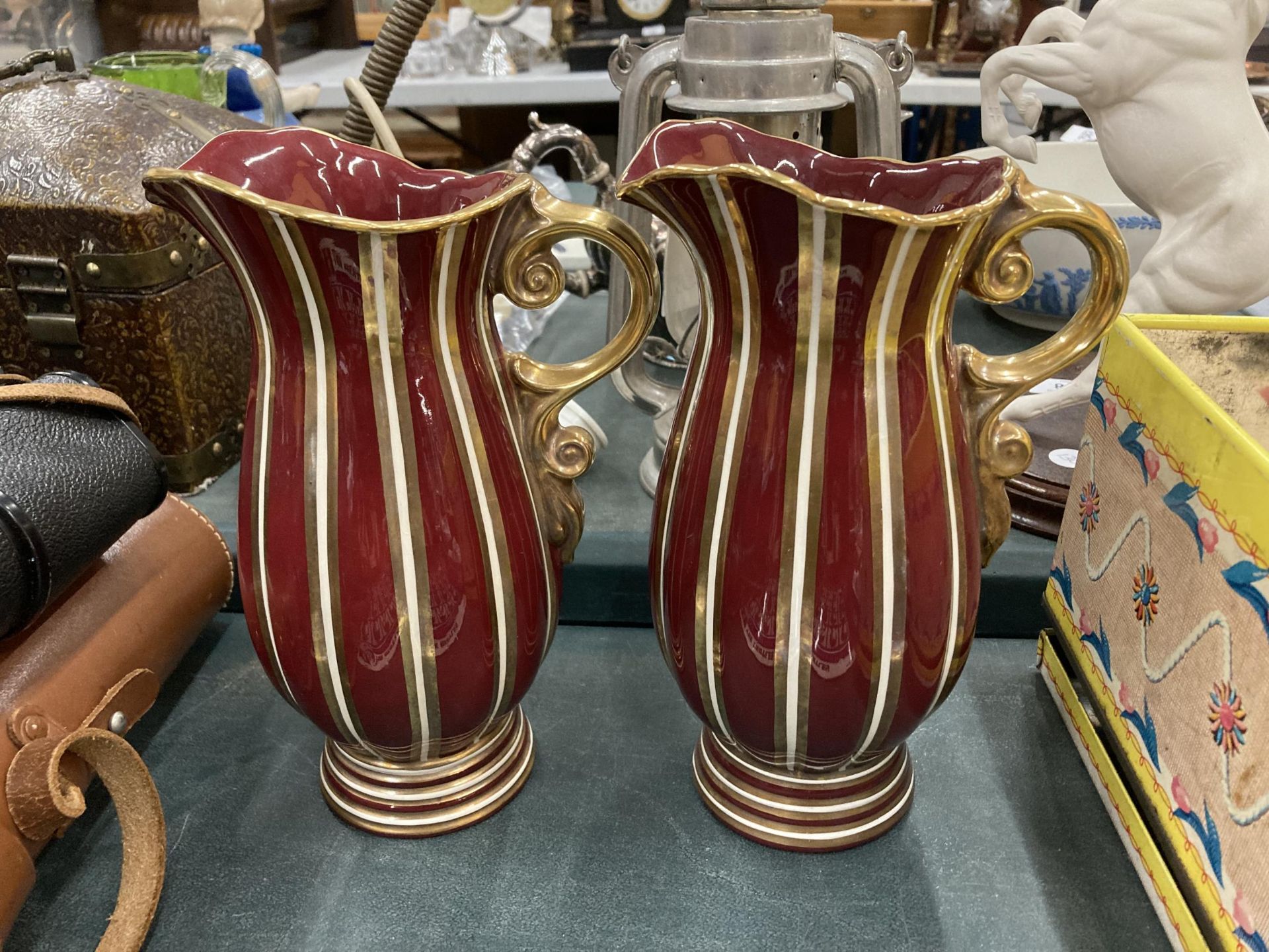 A PAIR OF RED AND GILT DESIGN WADE EMPRESS PATTERN JUGS