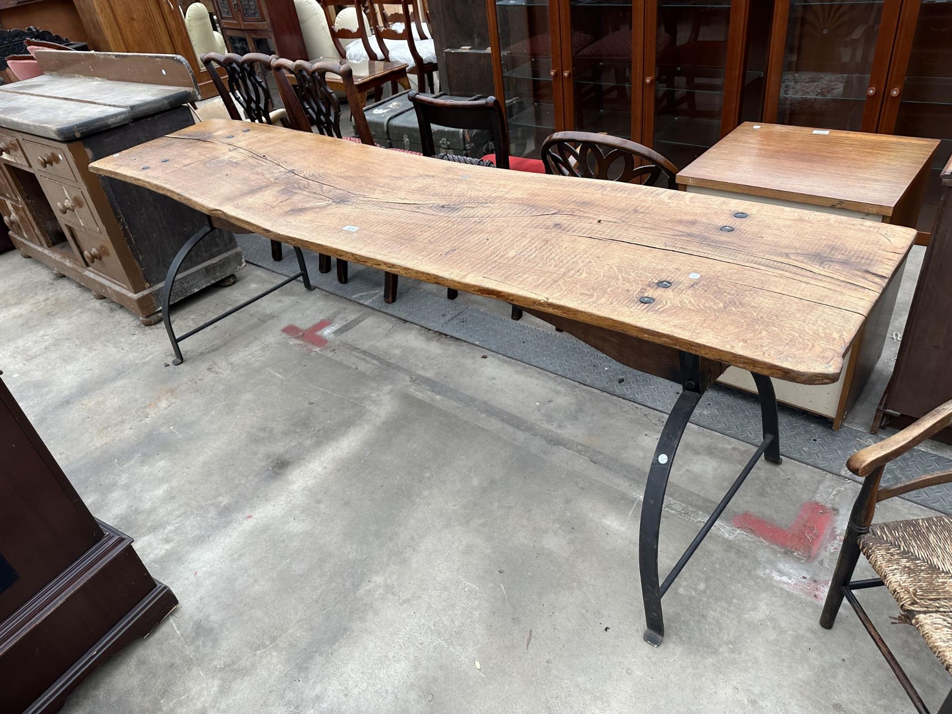 A LARGE RUSTIC DINING TABLE WITH CAST IRON STIRRUP SHAPED END LEGS, 86 X 22"