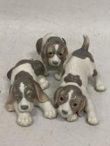A GROUP OF THREE LLADRO PUPPY DOG FIGURES