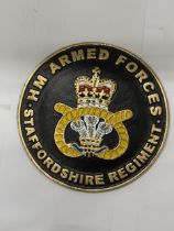 A CAST SIGN 'HM ARMED FORCES STAFFORDSHIRE REGIMENT', DIAMETER 24CM