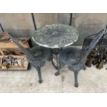 A CAST ALLOY BISTRO SET COMPRISING OF A ROUND TABLE AND TWO CHAIRS