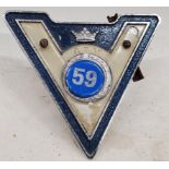 A VINTAGE 'V' CAR BADGE