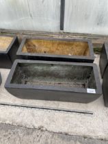 A PAIR OF LOW FIBRE GLASS TROUGH PLANTERS (L:50CM)