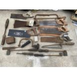 AN ASSORTMENT OF VINTAGE TOOLS TO INCLUDE SAWS AND FORGING TOOLS ETC