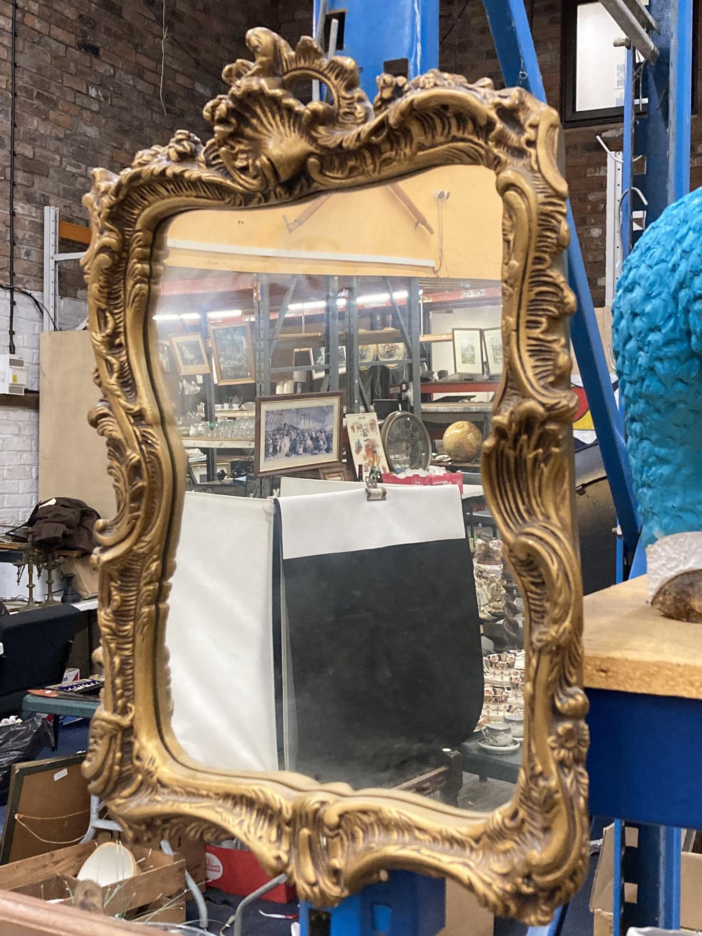 A GILT FRAMED DECORATIVE MIRROR