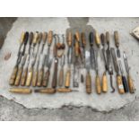 A LARGE ASSORTMENT OF WOODEN HANDLES CHISELS AND LATHE TOOLS ETC
