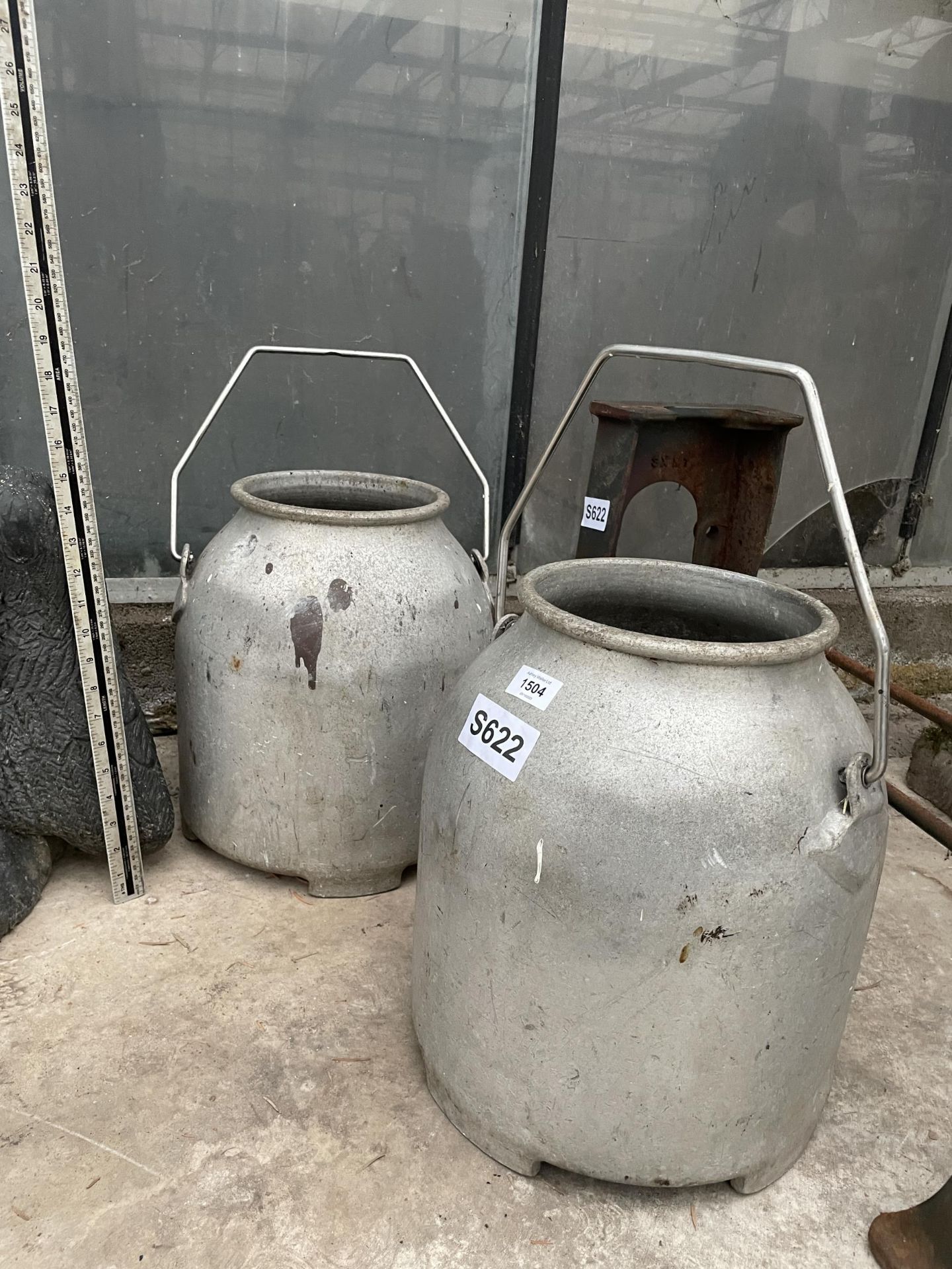A PAIR OF STAINLESS STEEL MILKING BUCKETS