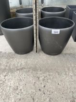 A SET OF FOUR SMALL ROUND MODERN FIBRE GLASS LECHUZA PLANTERS