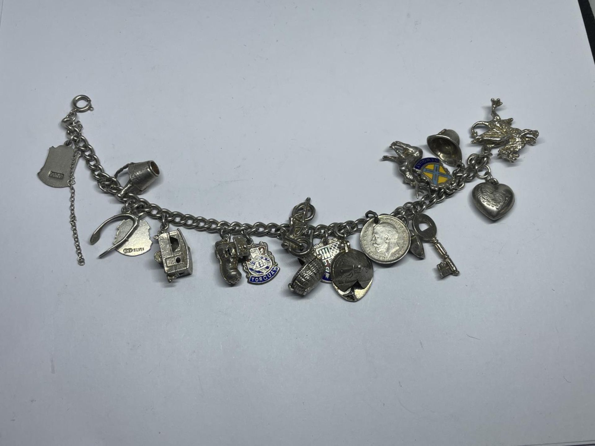 A SILVER CHARM BRACELET WITH NINETEEN VARIOUS CHARMS WEIGHT 49 GRAMS - Image 2 of 2