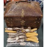 A BRASS BOUND DOMED BOX WITH CONTENTS TO INCLUDE FLATWARE AND SOUVENIR TEASPOONS
