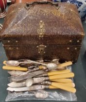 A BRASS BOUND DOMED BOX WITH CONTENTS TO INCLUDE FLATWARE AND SOUVENIR TEASPOONS