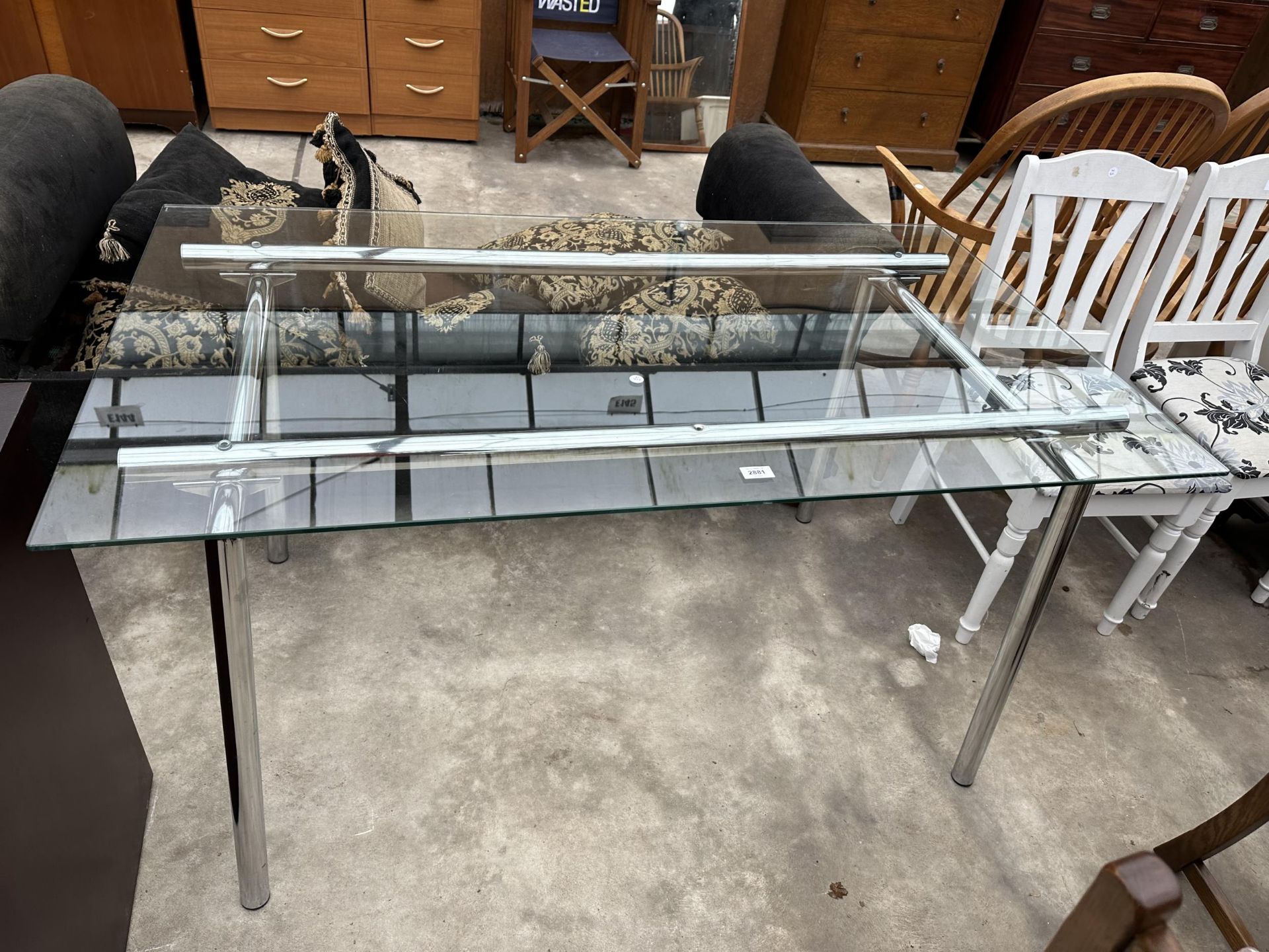 A RETRO DINING TABLE WITH GLASS TOP ON TUBULAR POLISHED CHROME BASE, 55 X 31.5"