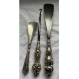 A SET OF THREE HALLMARKED SILVER HANDLED ITEMS - TWO SHOE HORNS AND BUTTON HOOK, GROSS WEIGHT 222
