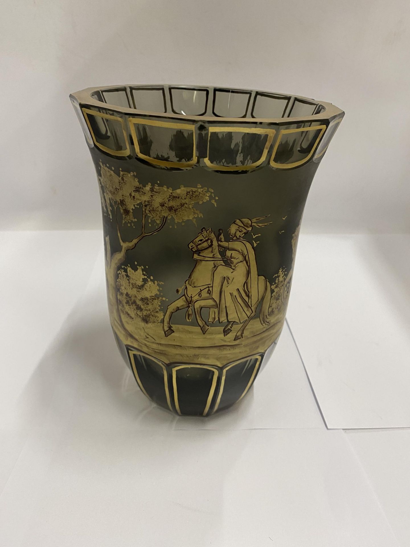 A BOHEMIAN CUT GLASS VASE WITH SCCENES OF FIGURES ON HORSEBACK, INDISTINCTLY SIGNED - SMALL CHIP