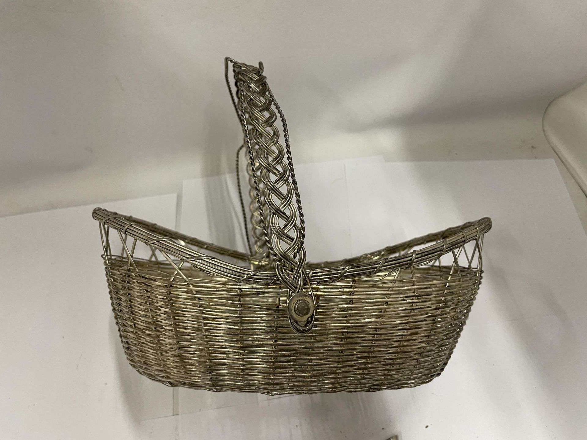 A VINTAGE WHITE METAL WINE HOLDER BASKET AND TWO SILVER PLATED HOLDERS - Image 3 of 3