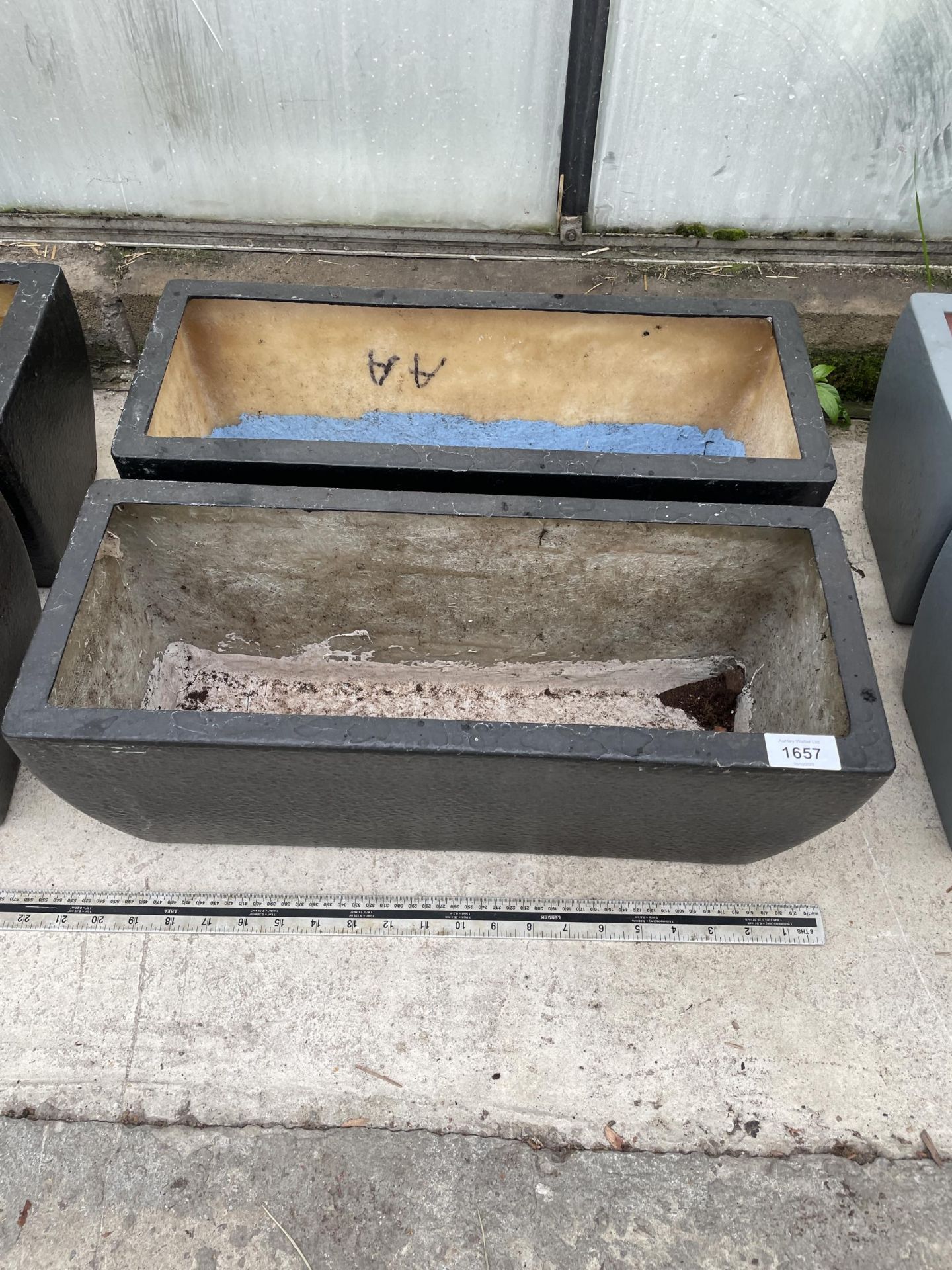 A PAIR OF LOW FIBRE GLASS TROUGH PLANTERS (L:50CM)