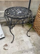 A LOW WROUGHT IRON FOUR LEGED STOOL