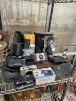 A LARGE ASSORTMENT OF CAMERA EQUIPMENT TO INLCUDE CAMERAS AND BINOCULARS ETC