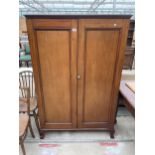 AN EARLY 20TH CENTURY PANELLED TWO DOOR CUPBOARD ON BALL AND CLAW FEET, 41.5" WIDE