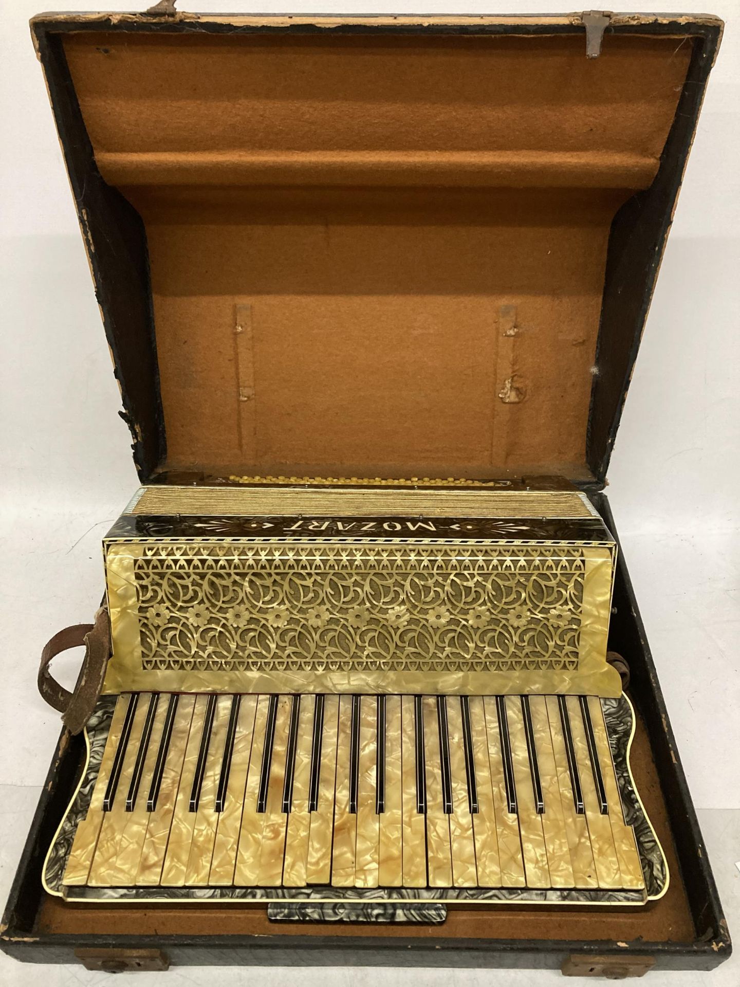 A VINTAGE CASED MOZART ACCORDION WITH INLAID DESIGN