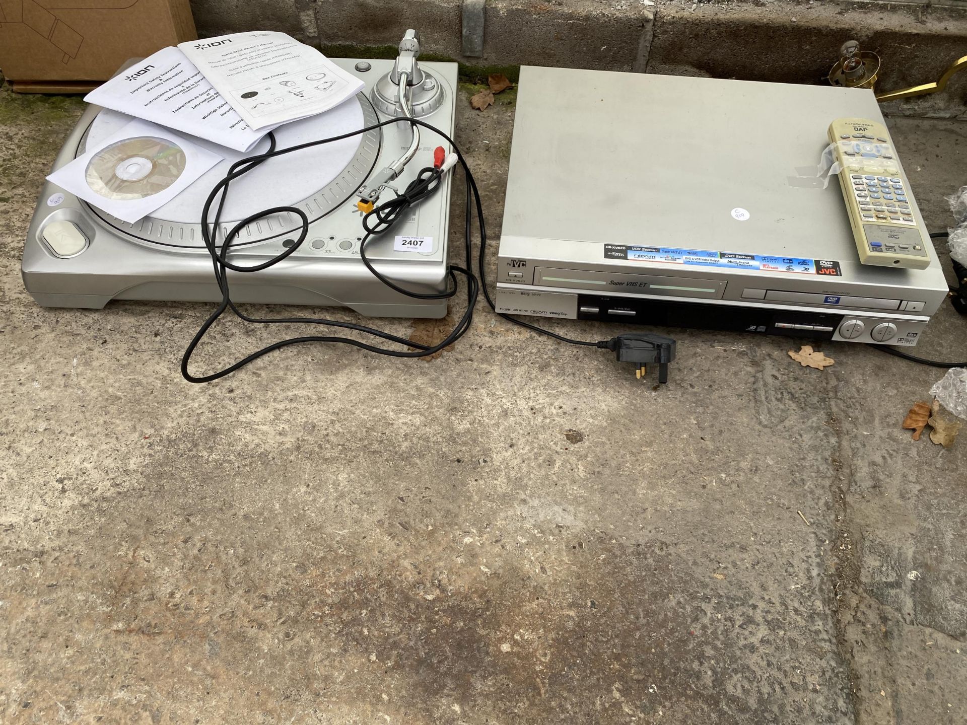 A RECORD PLAYER AND A JVC VHS/DVD PLAYER
