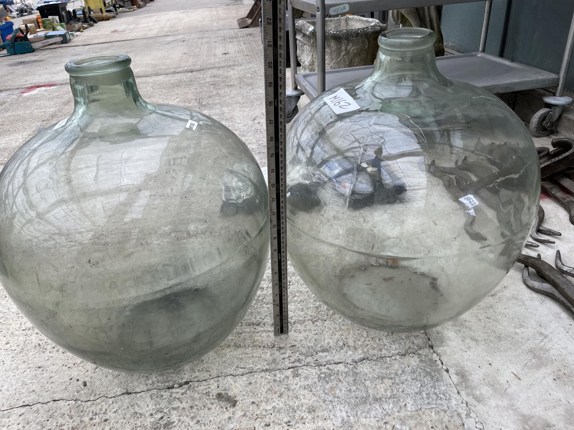 A PAIR OF LARGE VINTAGE GLASS CARBOYS