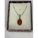 A BOXED SILVER AND AMBER NECKLACE