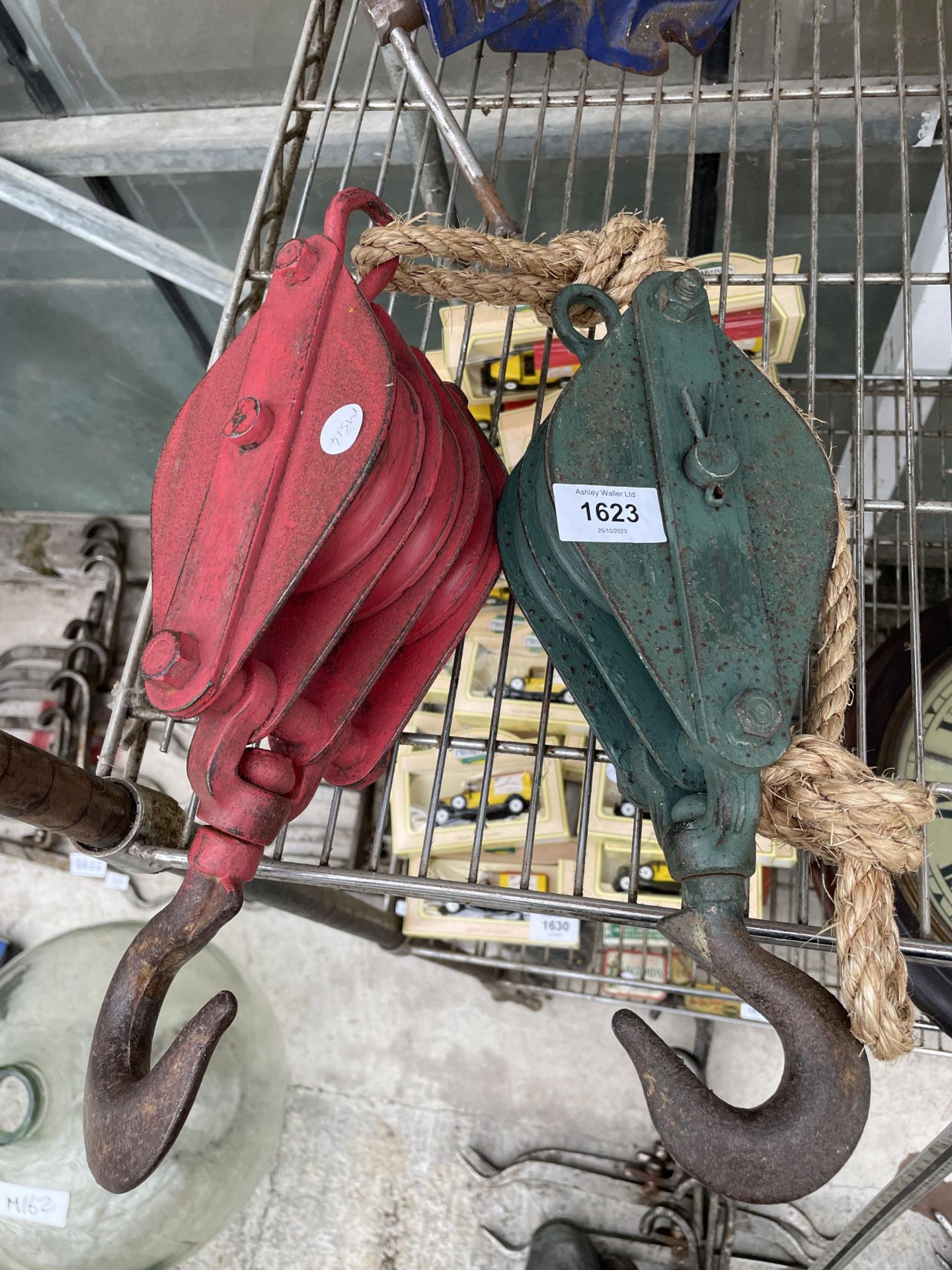 TWO VINTAGE METAL PULLEY WHEELS AND HOOKS