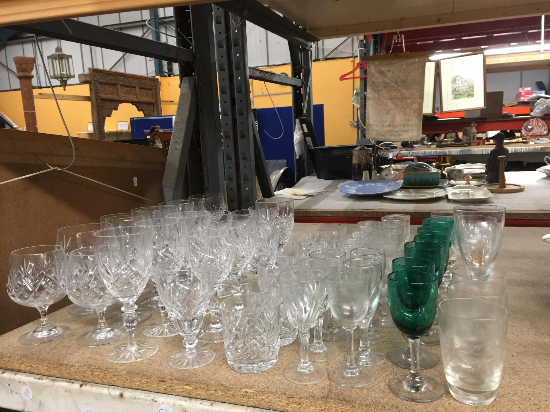 A COLLECTION OF CUT GLASS DRINKING GLASSES, GREEN GOBLETS ETC