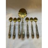 SEVEN .800 GRADE SILVER HANDLED AND BRASS SPOONS COMPRISING SET OF SIX AND A LARGER SERVING EXAMPLE,