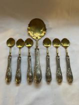 SEVEN .800 GRADE SILVER HANDLED AND BRASS SPOONS COMPRISING SET OF SIX AND A LARGER SERVING EXAMPLE,