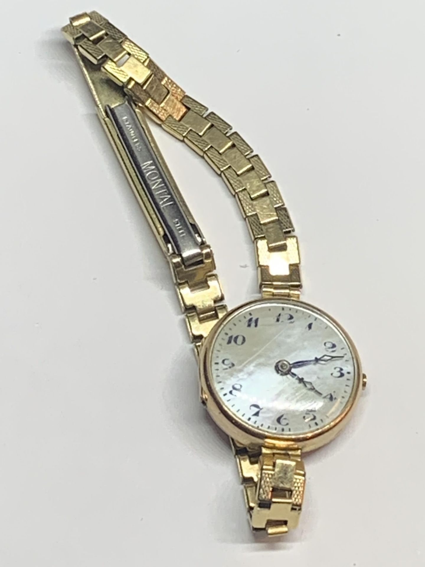 A VINTAGE WRIST WATCH WITH 9 CARAT GOLD CASE AND GOLD PLATED STRAP