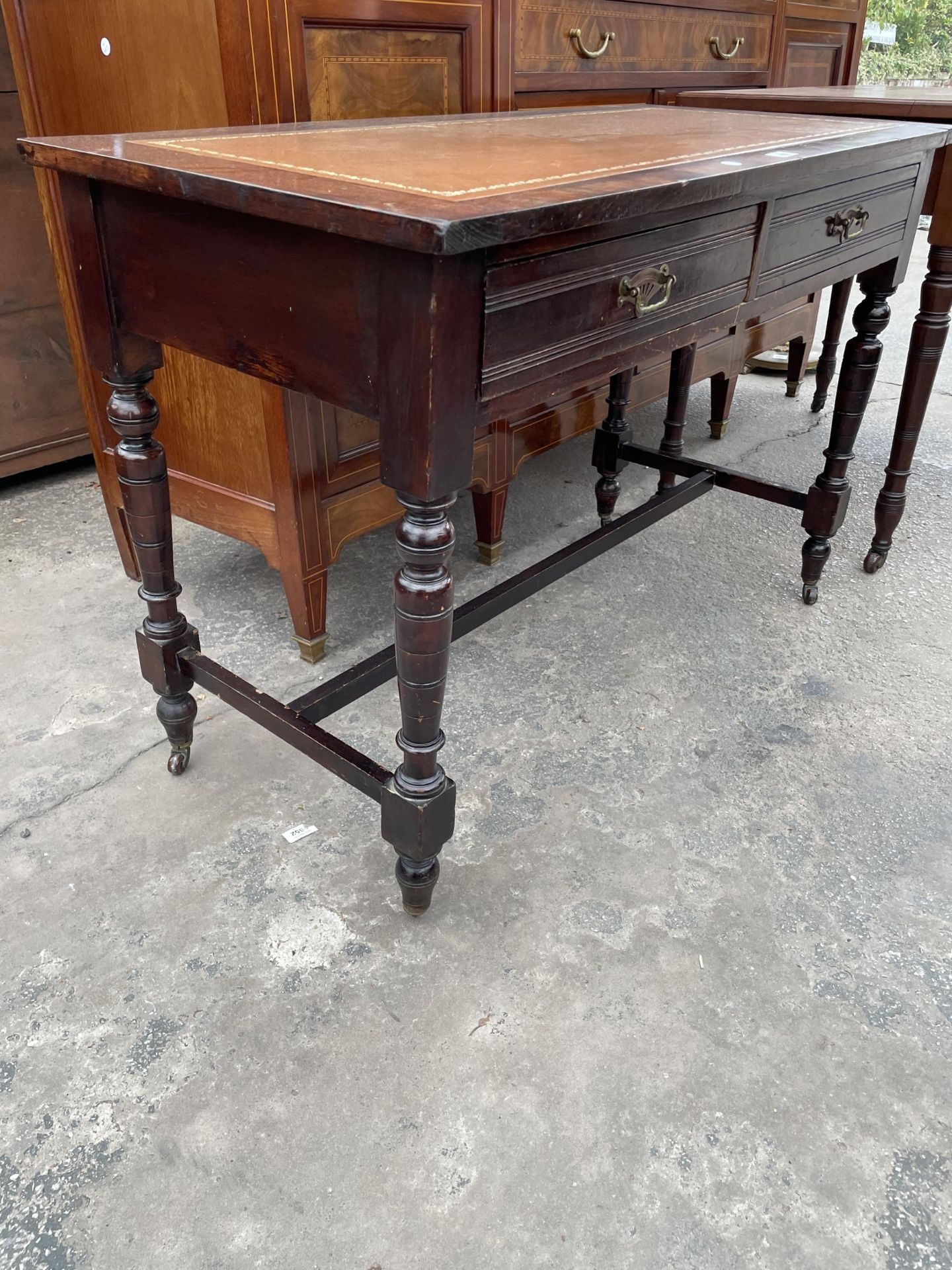 A LATE VICTORIAN SIDE-TABLE WITH TWO DRAWERS, ON TURNED LEGS, WITH INSET LEATHER TOP, 42" WIDE - Image 2 of 3