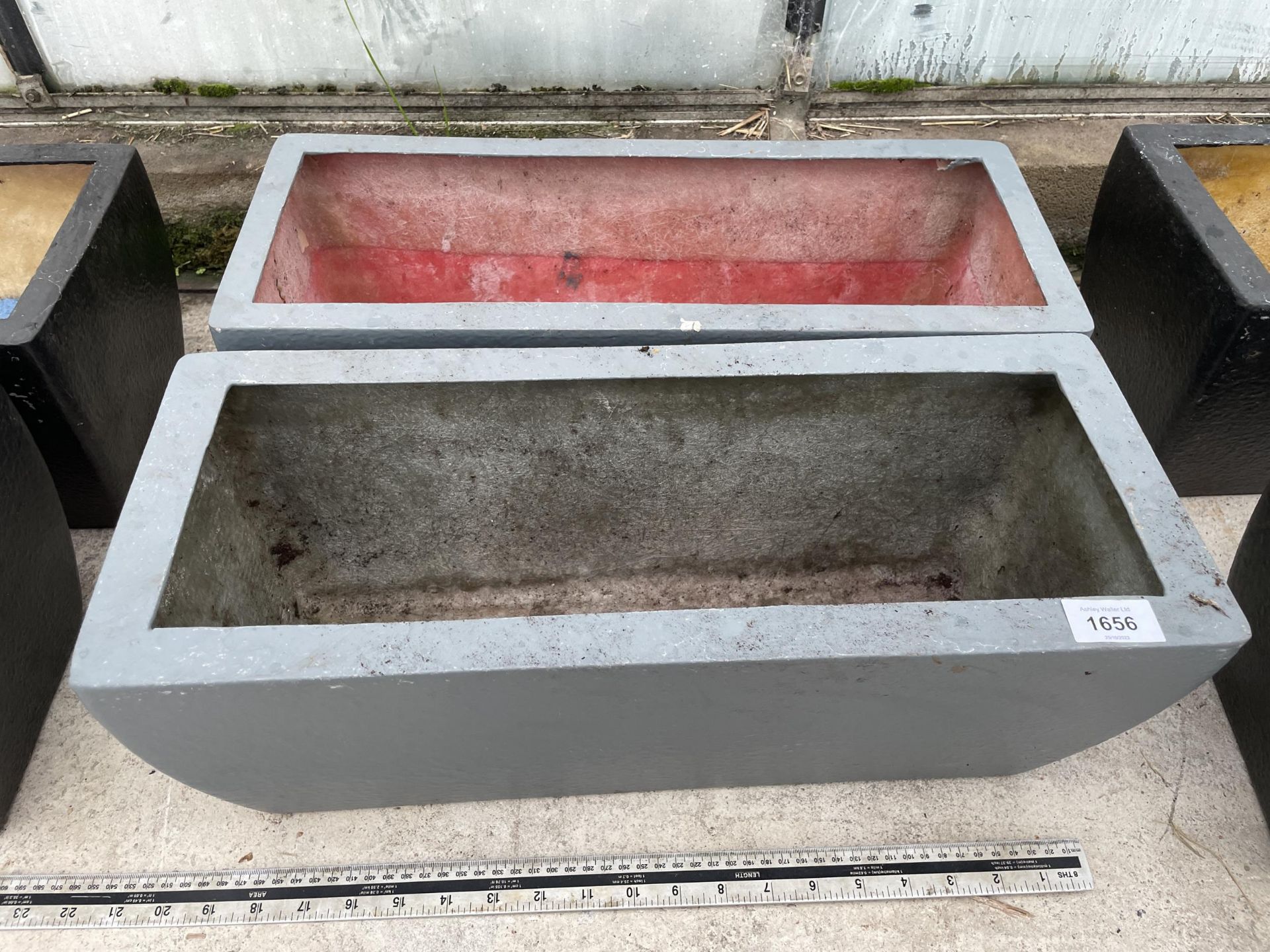 A PAIR OF LOW FIBRE GLASS TROUGH PLANTERS (L:50CM)