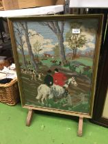 A VINTAGE FIRE SCREEN WITH A TAPESTRY HUNT SCENE WITH A WOODEN AND METAL FRAME, 49CM X 68CM