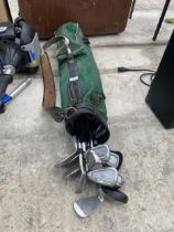 A VINTAGE GOLF BAG AND AN ASSORTMENT OF GOLF CLUBS