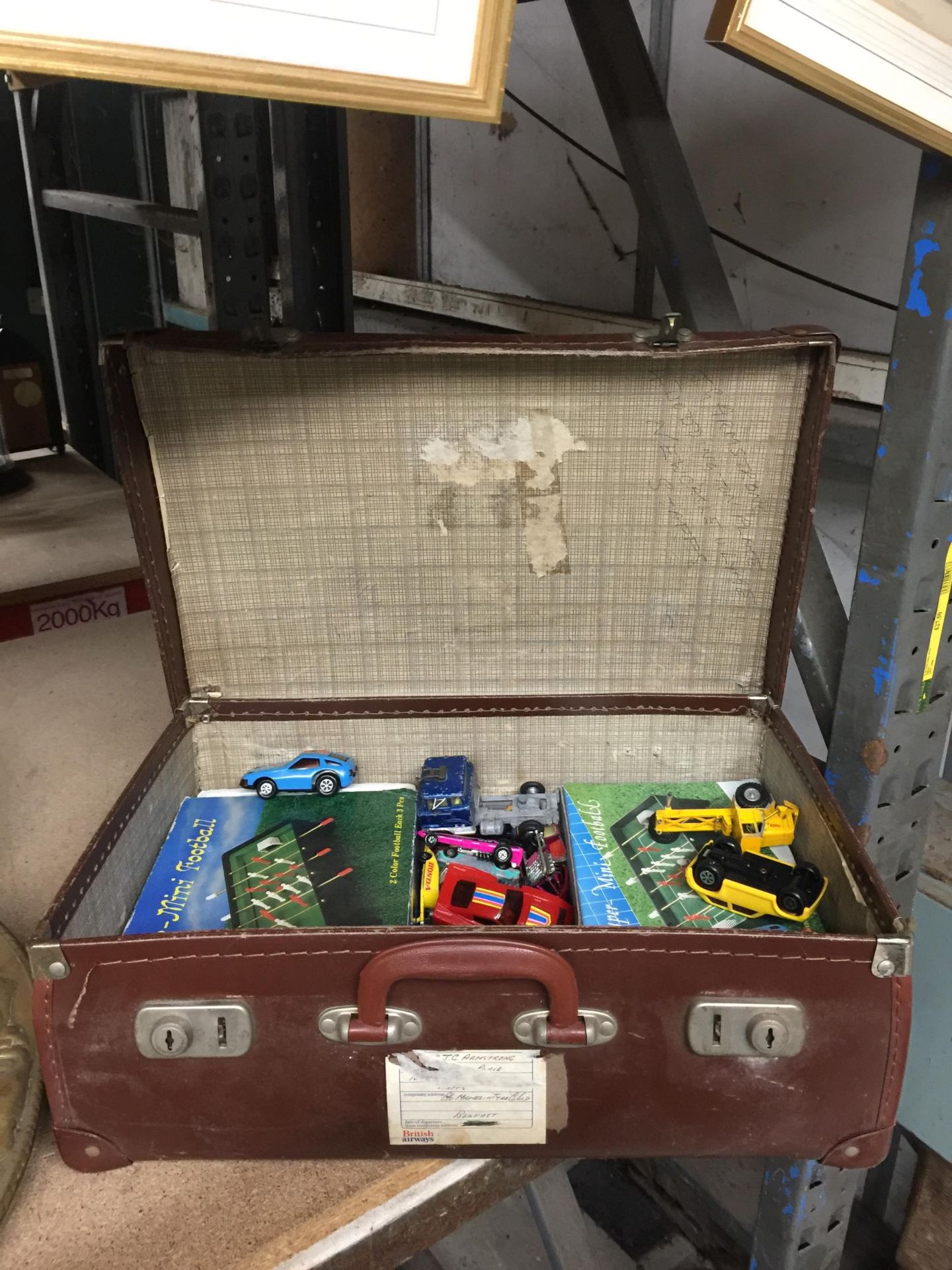 A VINTAGE SUITCASE OF ASSORTED VEHICLES, MINI FOOTBALL GAMES ETC