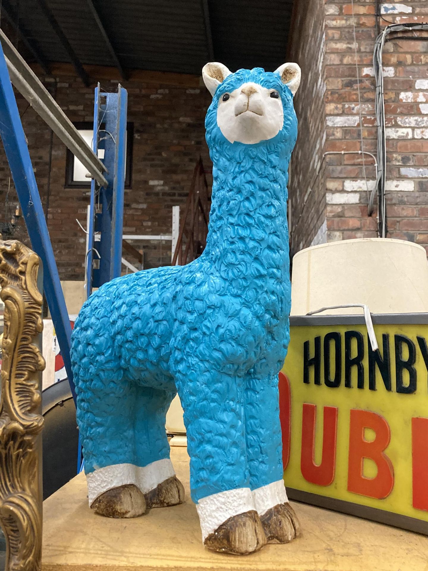 A LARGE TURQUOISE MODEL OF A LLAMA, HEIGHT 58CM