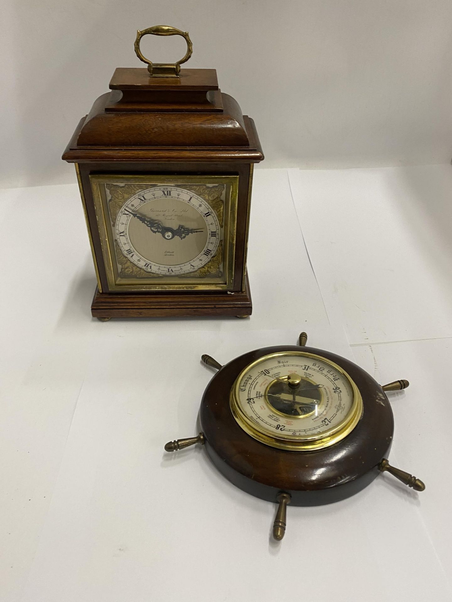 A HEAVY GARRARD AND CO MANTLE CLOCK PLUS A SMALL 'SHIP'S WHEEL' BAROMETER