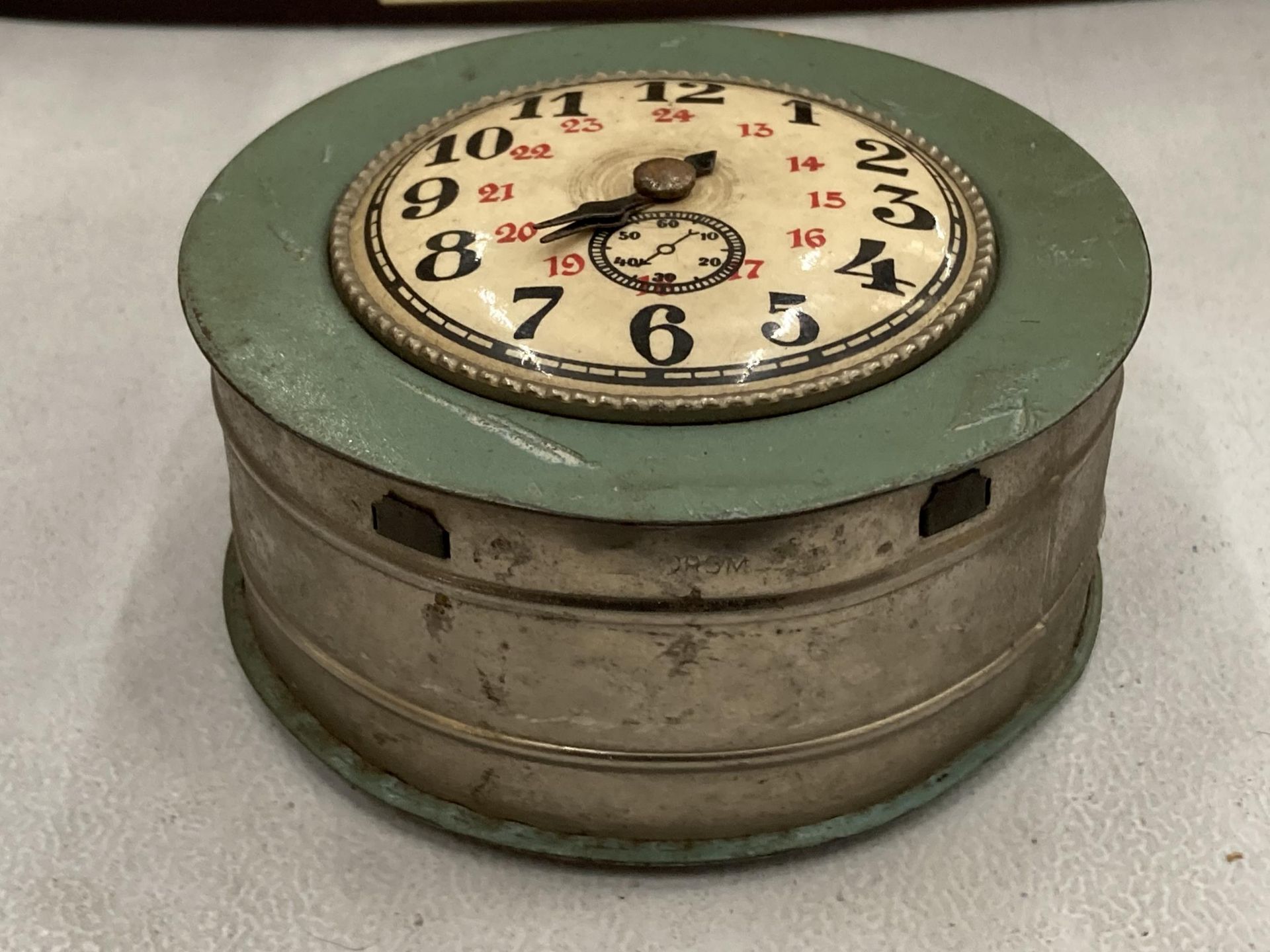 A TIN PLATE 'CLOCK' MONEY BOX