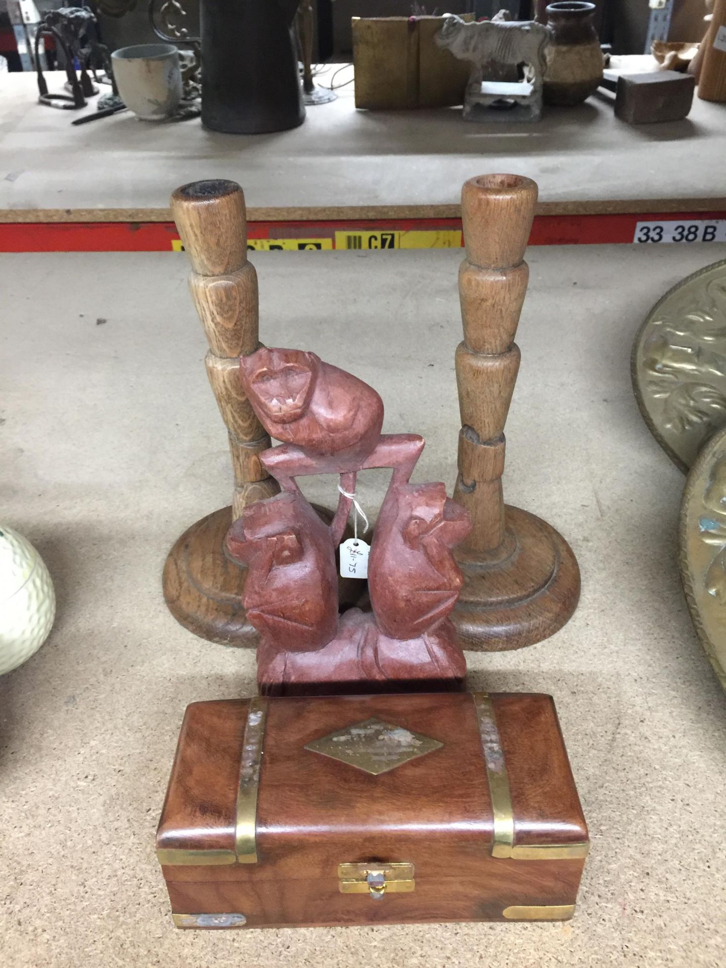 FOUR WOODEN ITEMS - BRASS BOUND BOX, PAIR OF CANDLESTICKS AND MONKEY CARVING - Image 4 of 4