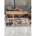 A VINTAGE WOODEN JOINERS CHEST WITH AN ASSORTMENT OF TOOLS TO INCLUDE G CLAMPS, WOOD PLANES AND SAWS
