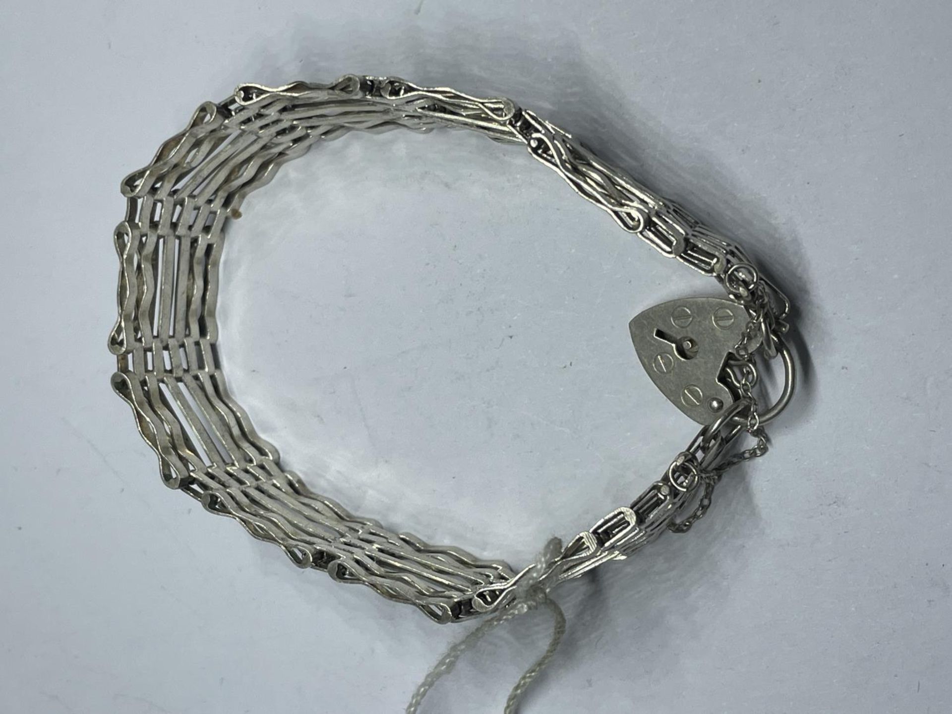 A MARKED SILVER SIX BAR GATE BRACELET WITH HEART PADLOCK WEIGHT 20 GRAMS