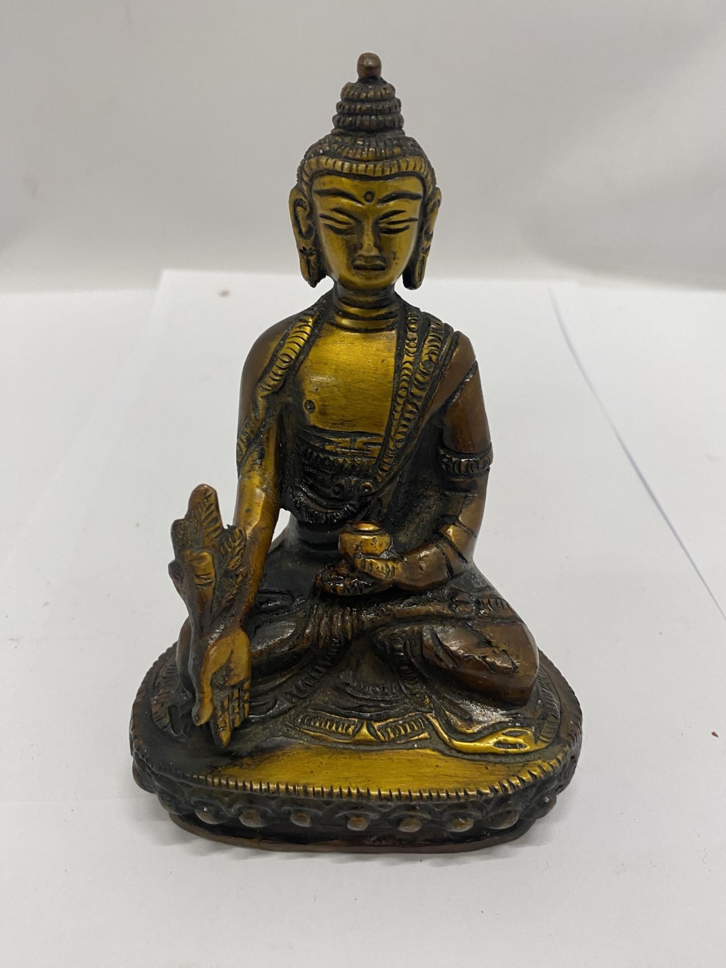 A BRONZE TIBETAN HEALING BUDDAH