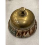 A VINTAGE BRASS AND POTTERY DESK BELL