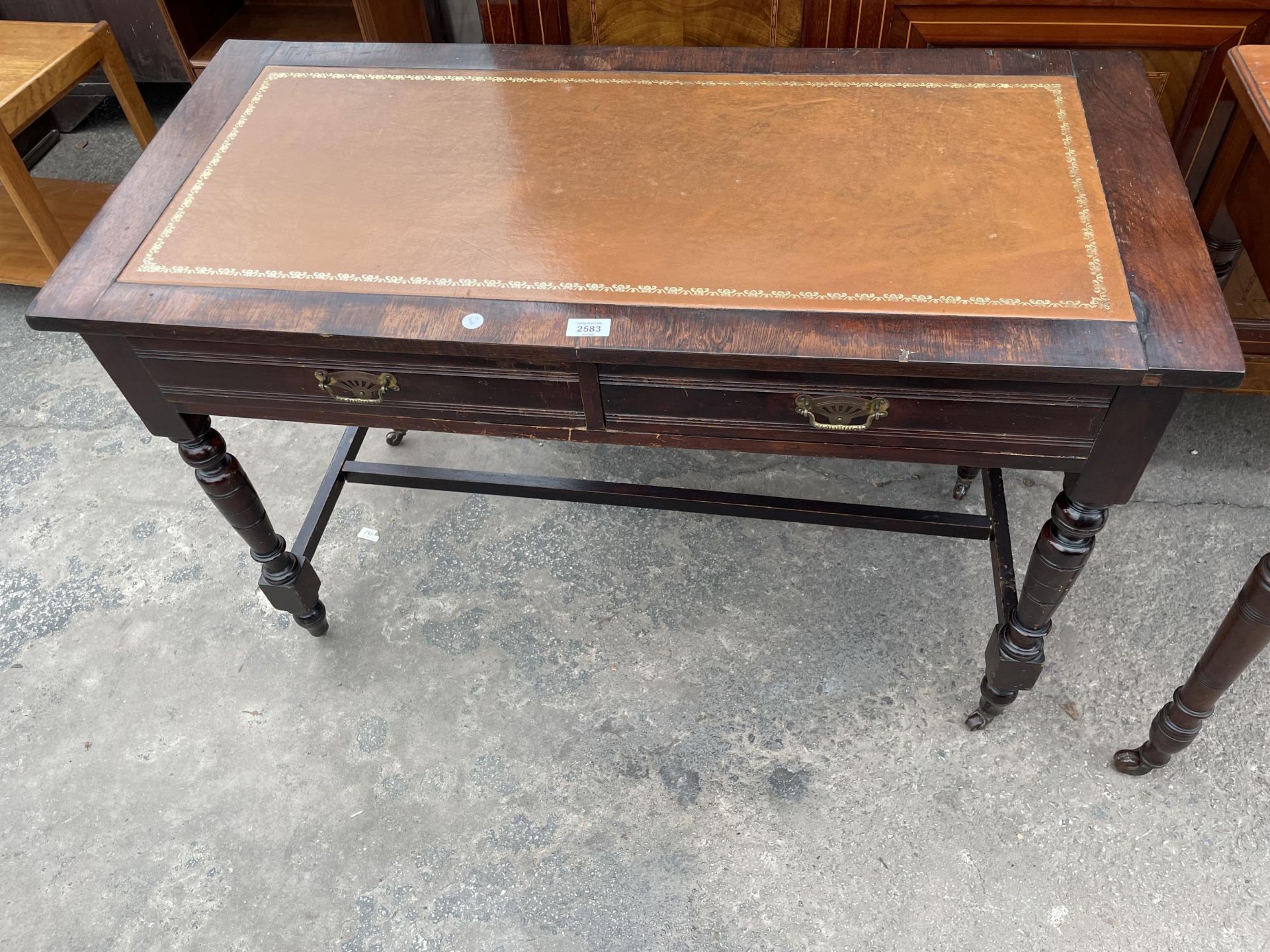 A LATE VICTORIAN SIDE-TABLE WITH TWO DRAWERS, ON TURNED LEGS, WITH INSET LEATHER TOP, 42" WIDE