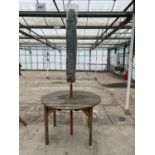 AN AS NEW EX DISPLAY CHARLES TAYLOR CIRCULAR TABLE WITH A GREY PARASOL + VAT