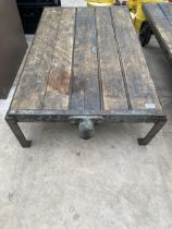 A VINTAGE WOODEN AND METAL TWO WHEELED PLATFORM TROLLEY