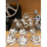 A VINTAGE PALISSY TEASET WITH FLORAL PATTERN ON A CREAM BACKGROUND TO INCLUDE CAKE PLATES, SUGAR