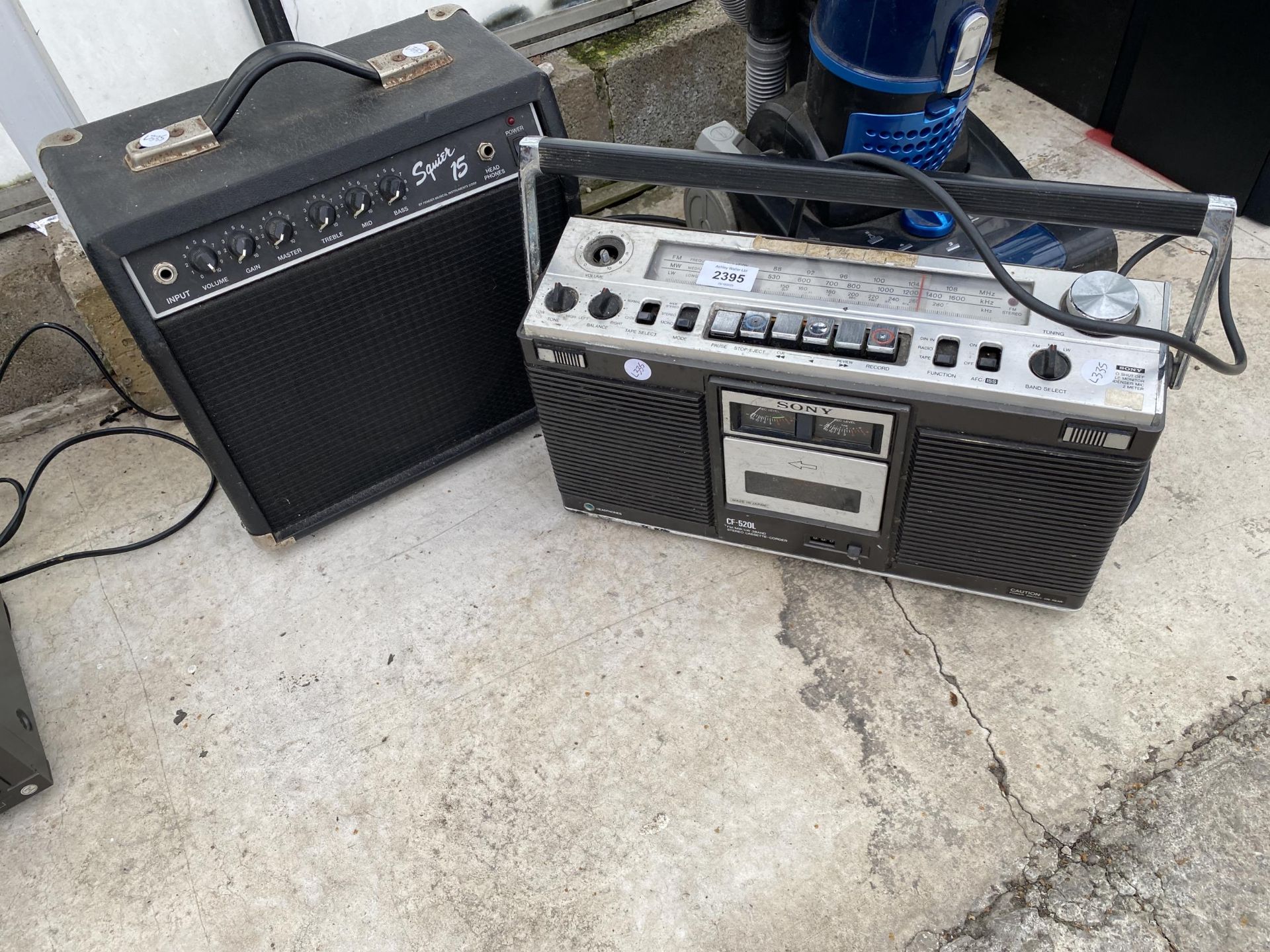 A RETRO SONY RADIO AND A SQUIRE 15 AMPLIFIER